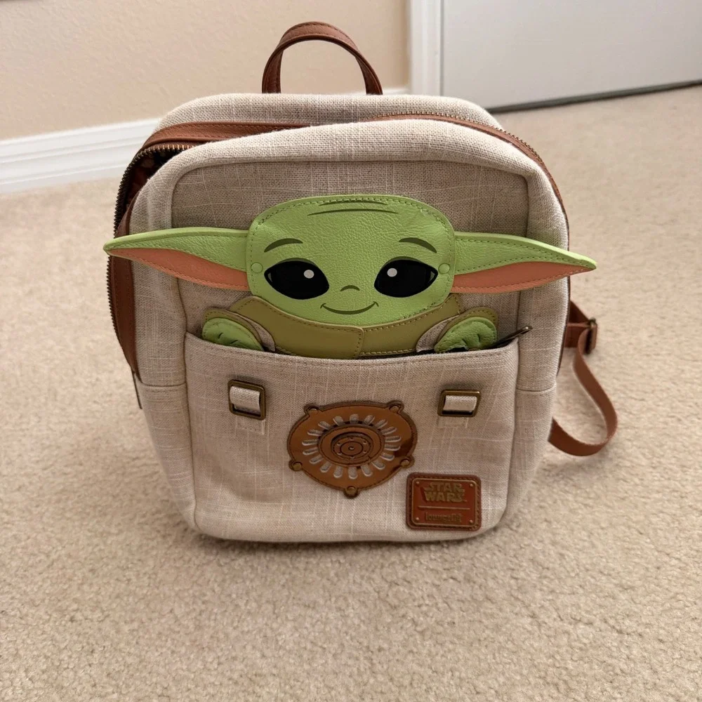 baby yoda mini backpack disney Star Wars: Mandalorian This adorable mini backpack features a hidden pocket behind an applique in the shape of a bag Disney Parks Loungefly Mini Backpack